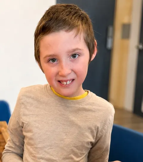 A child at a Youth Connect program smiling at the camera
