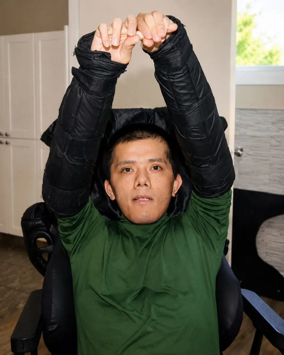 A man taking part in a supported strength and movement exercise