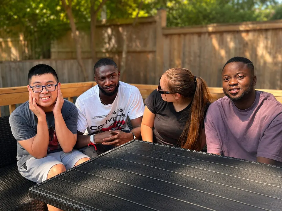 Young adults relaxing together on a patio at a Hopewell program